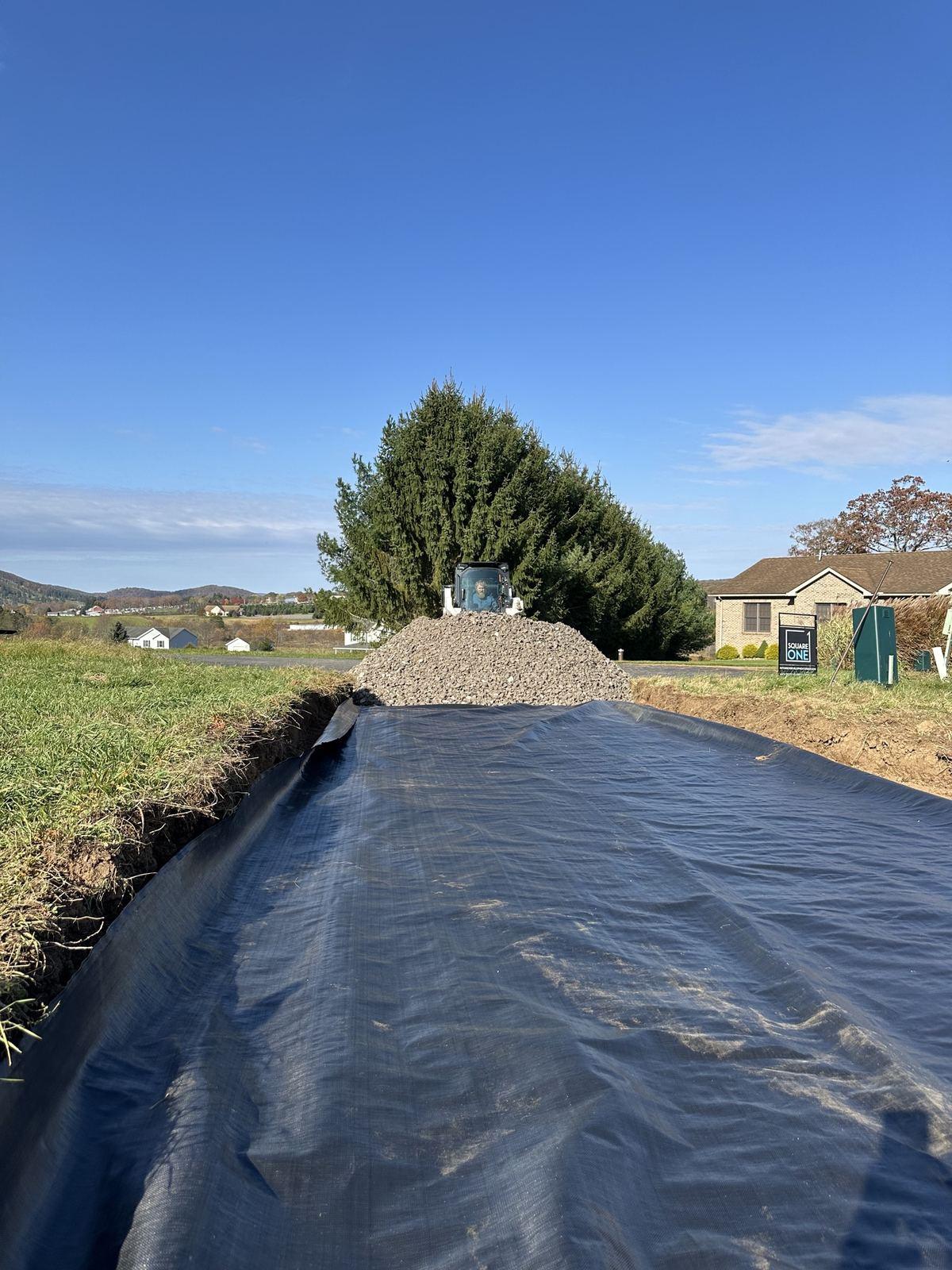 Geotextile fabric laid for the driveway base at Green Meadow.