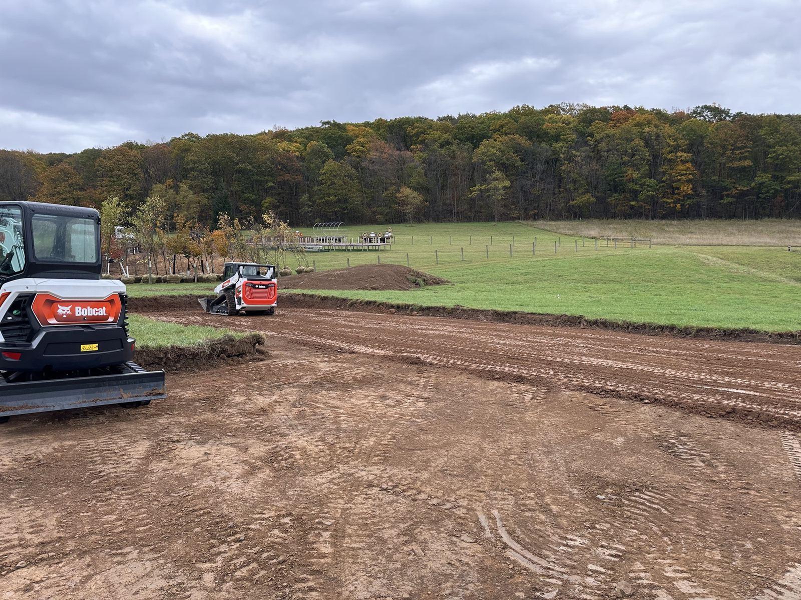 The Bobcat E35 in the foreground of the graded site at Green Meadow.