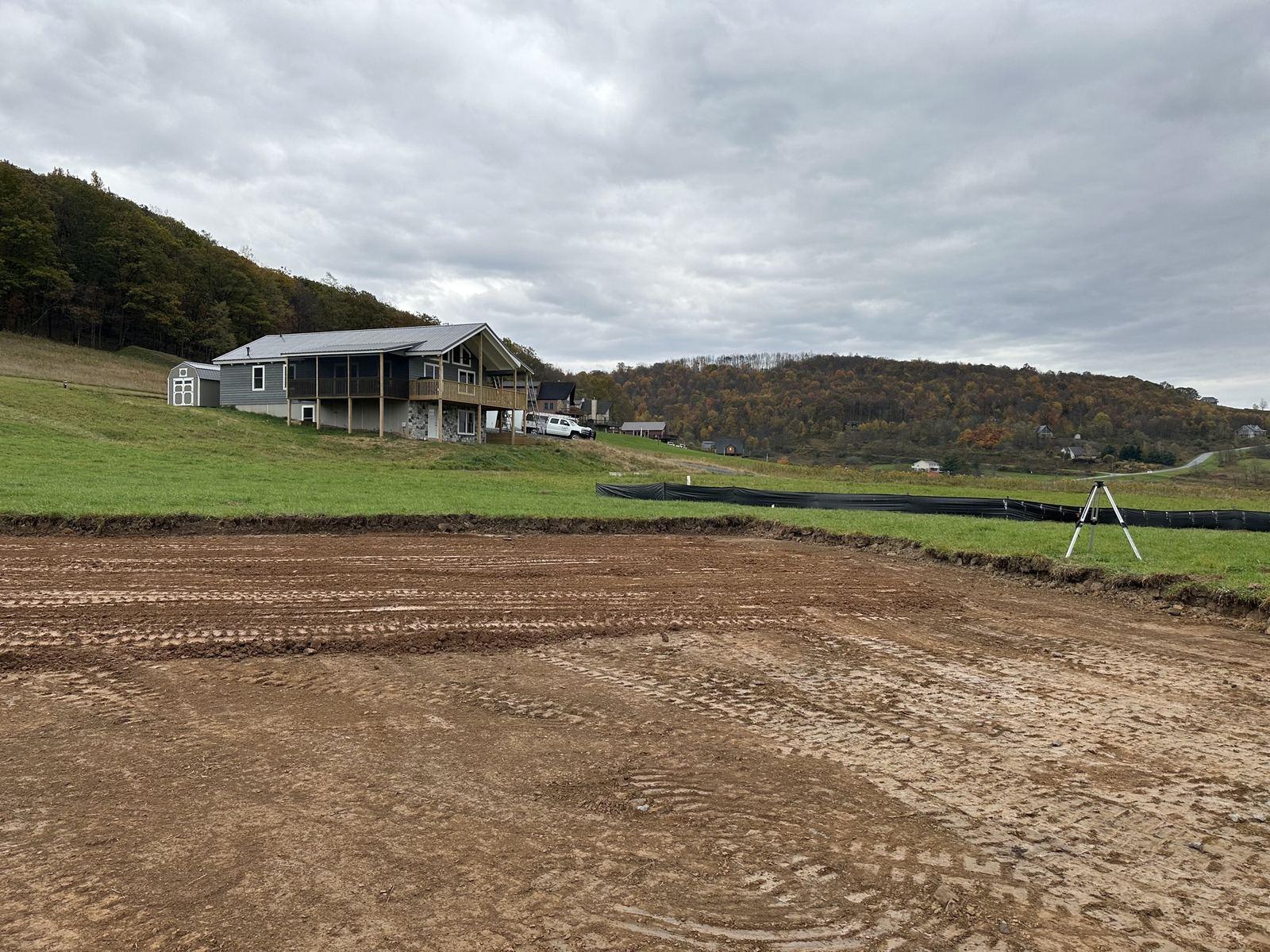 A fine-graded yard at Green Meadow, set so water moves away from the house.