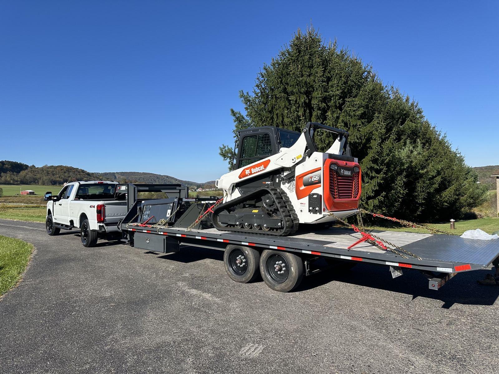 The Bobcat T66 chained down on a Lamar gooseneck at Green Meadow.
