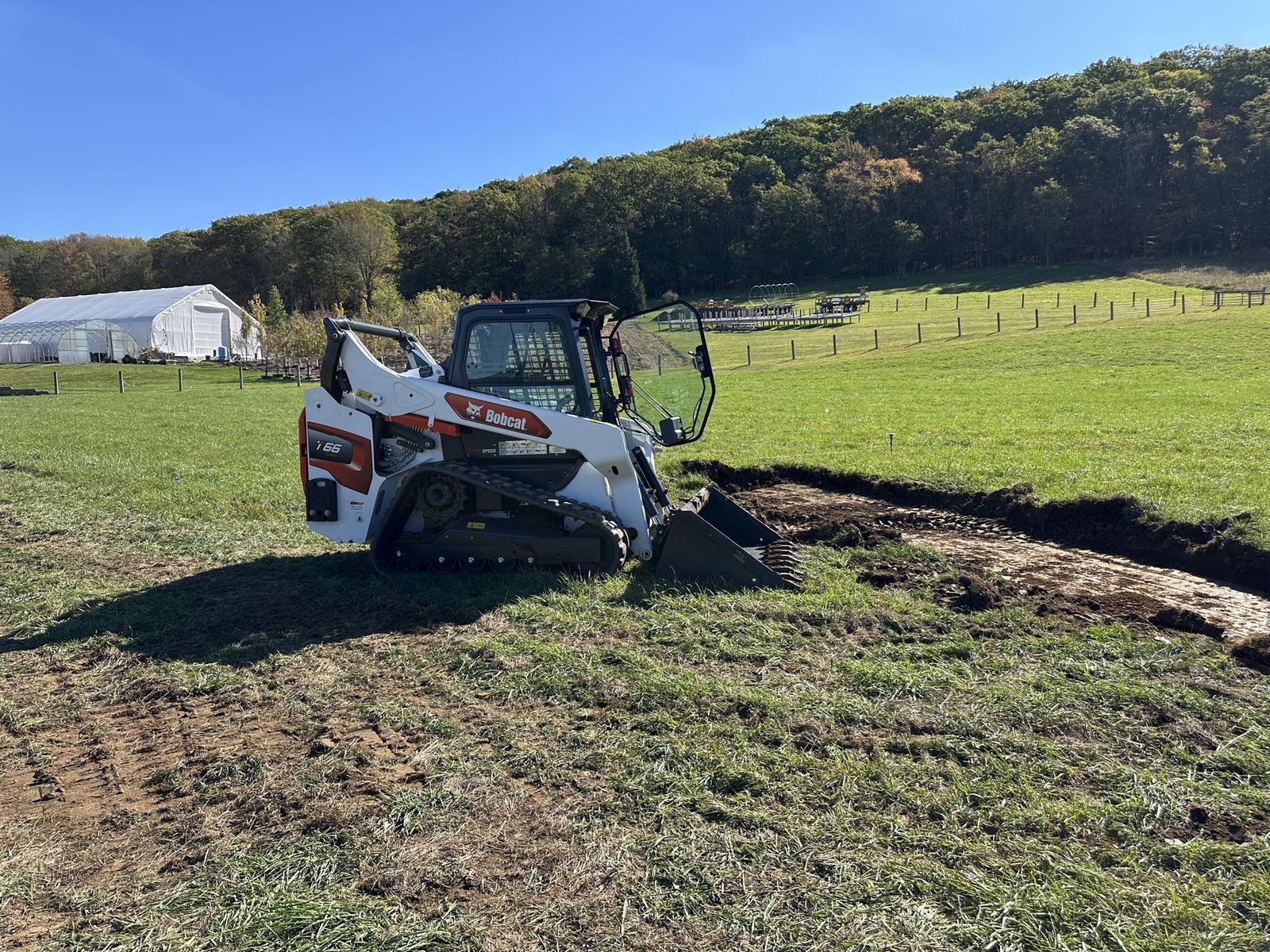 The T66 trenching at Green Meadow, with the farm buildings behind it.
