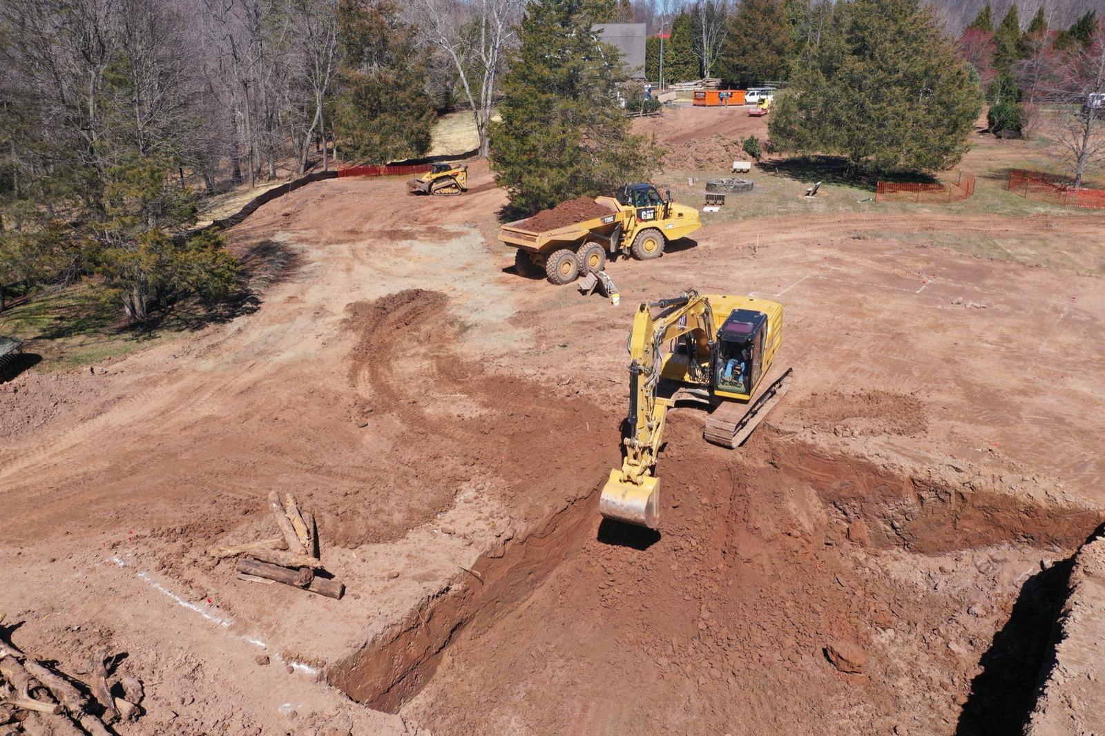 An excavator loading a dump truck on a building pad at Haymarket.