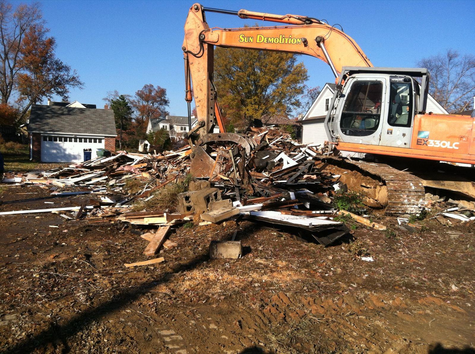 An excavator clearing demolition debris at High Street.