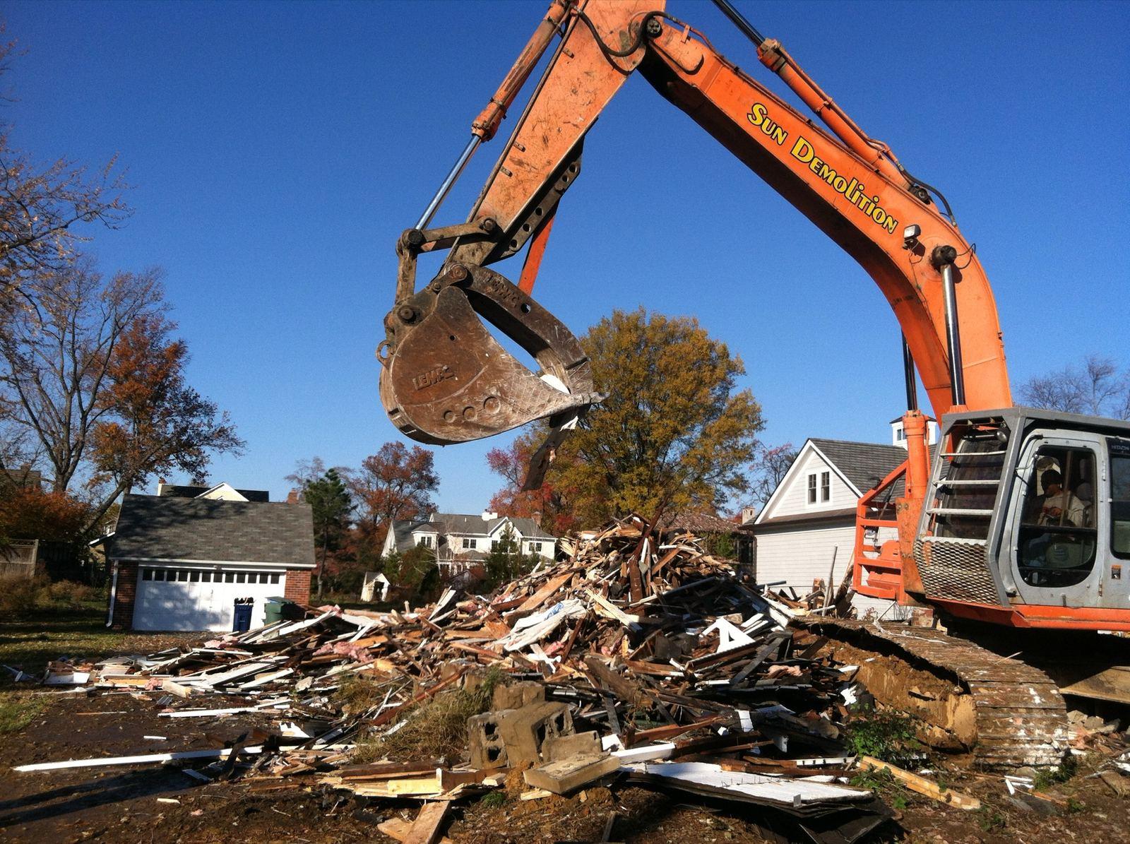 An excavator working through demolition debris at High Street.