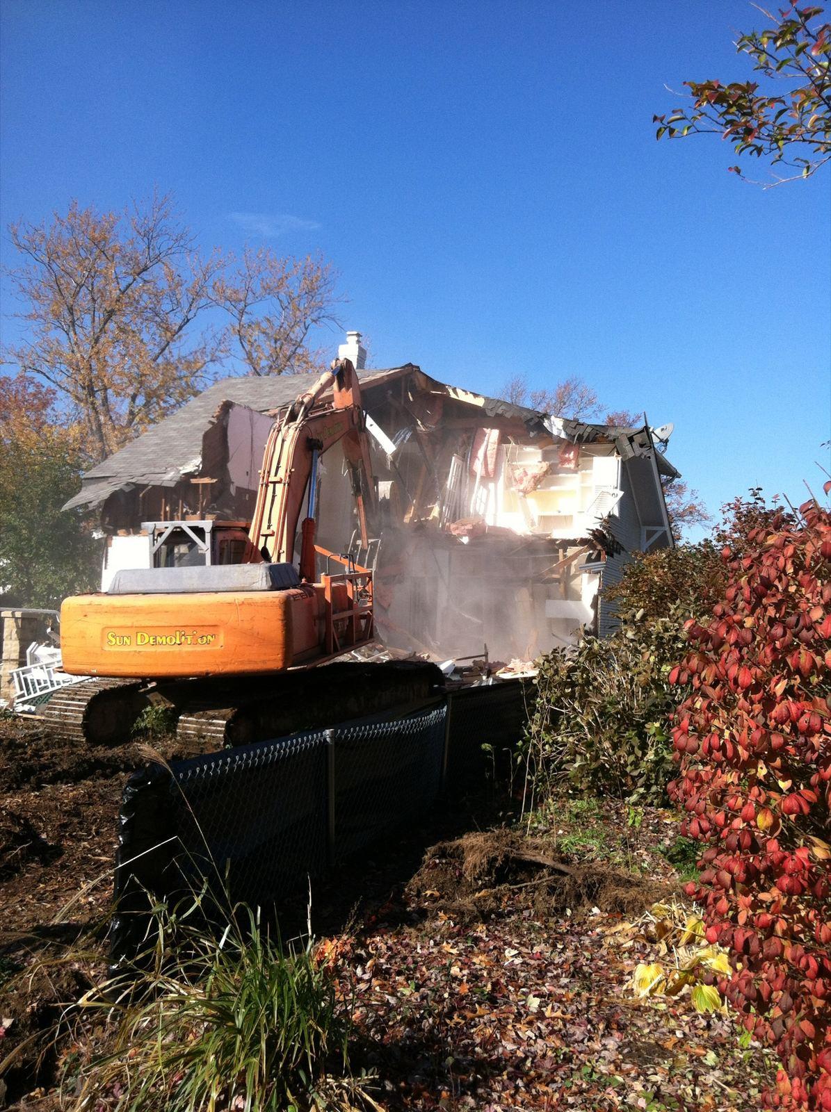 An excavator taking down a house at High Street.