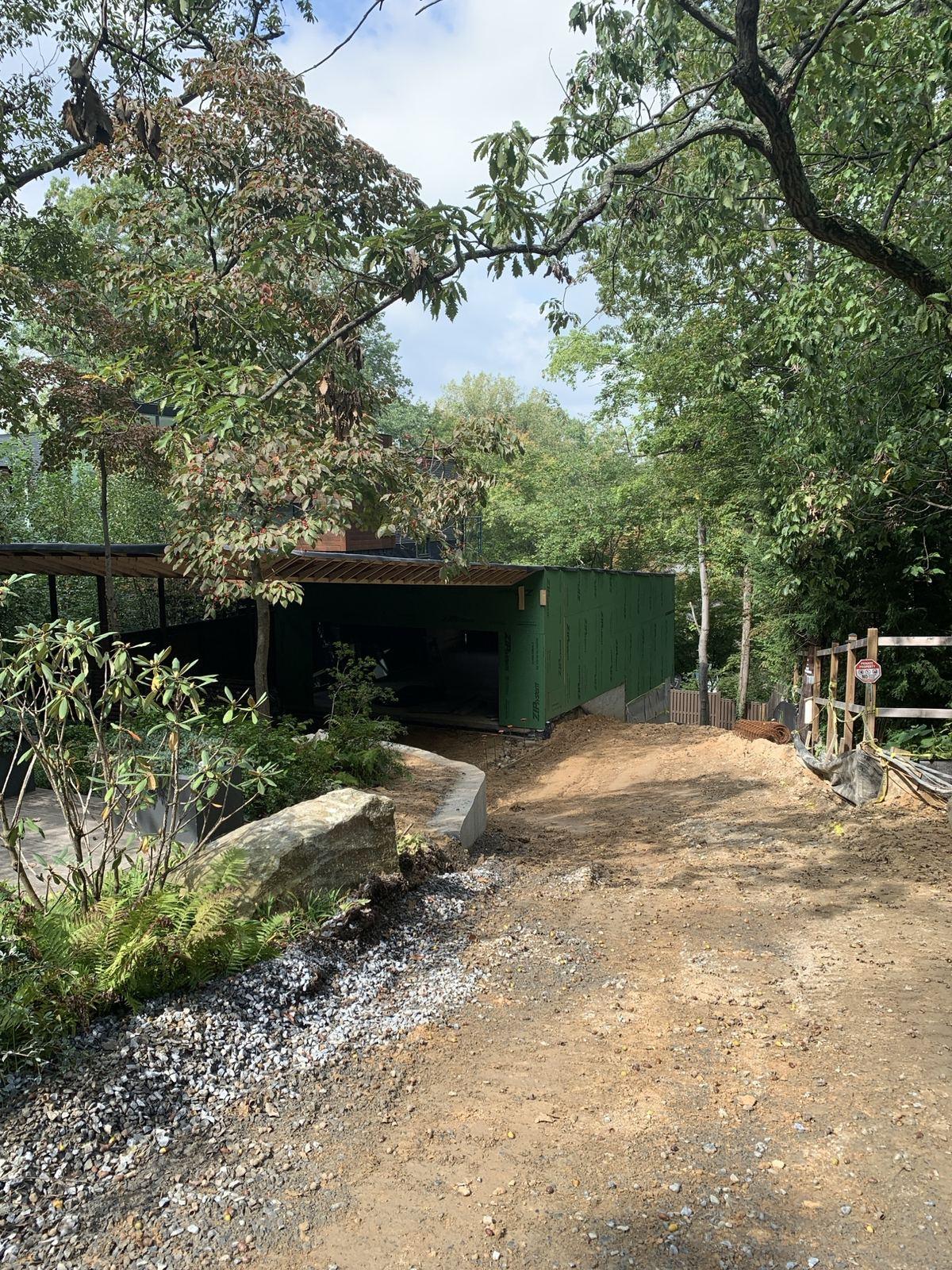 A stone drive through the woods to an outbuilding in Purcellville.