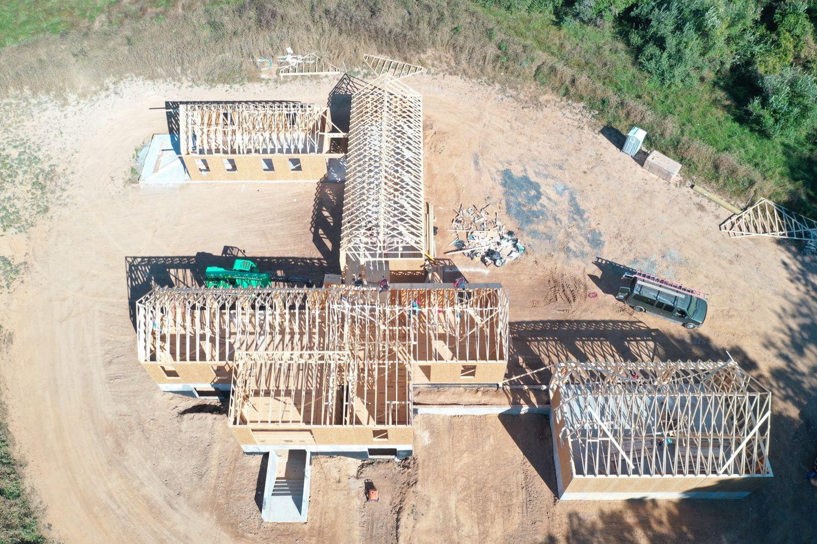 A house framed on a pad graded at the Purcellville project.