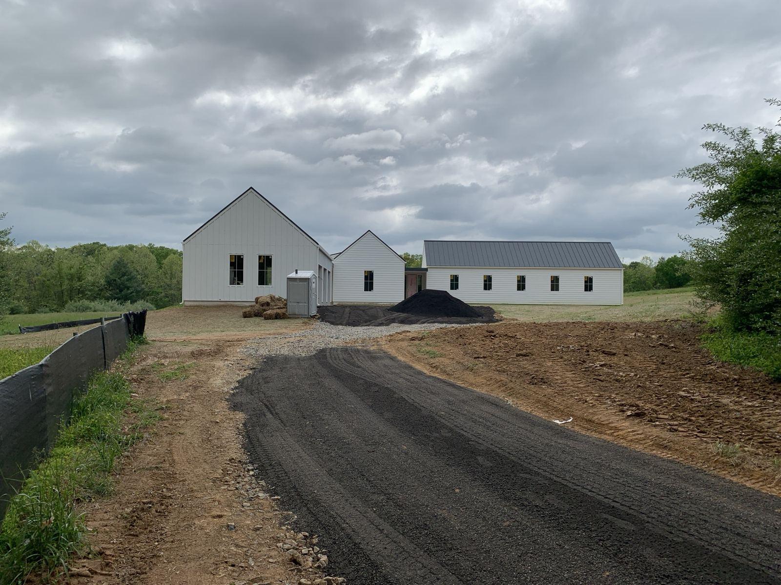 The paved driveway. This pair is the same project, not the identical camera position.