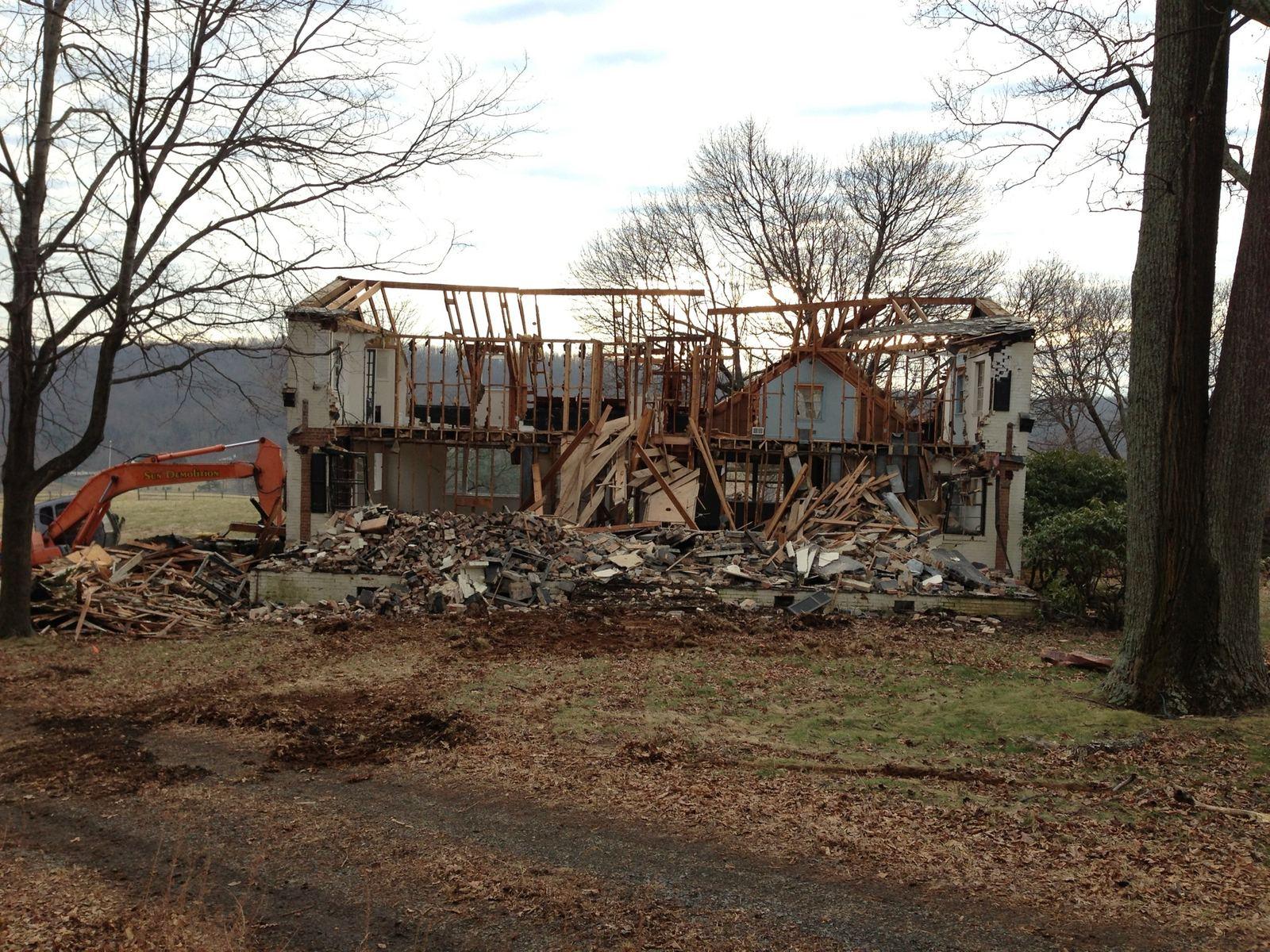 The house coming down among the trees.