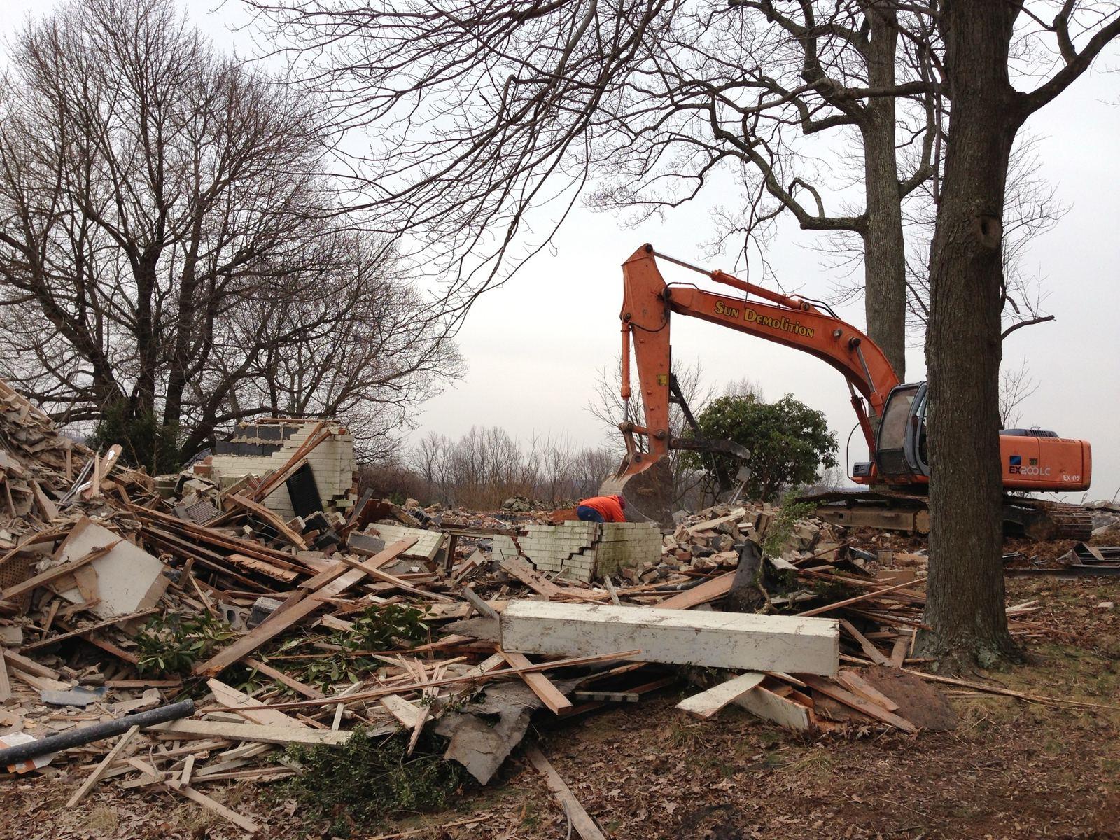 An excavator sorting demolition debris at Wildcat.